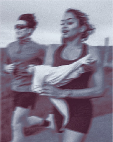 A man and woman running on a road