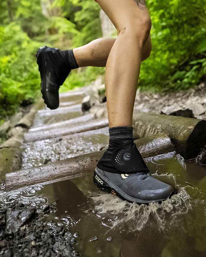 A person wearing Topo gaiters outside