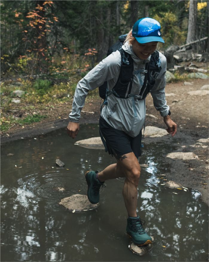 A person walking through a stream