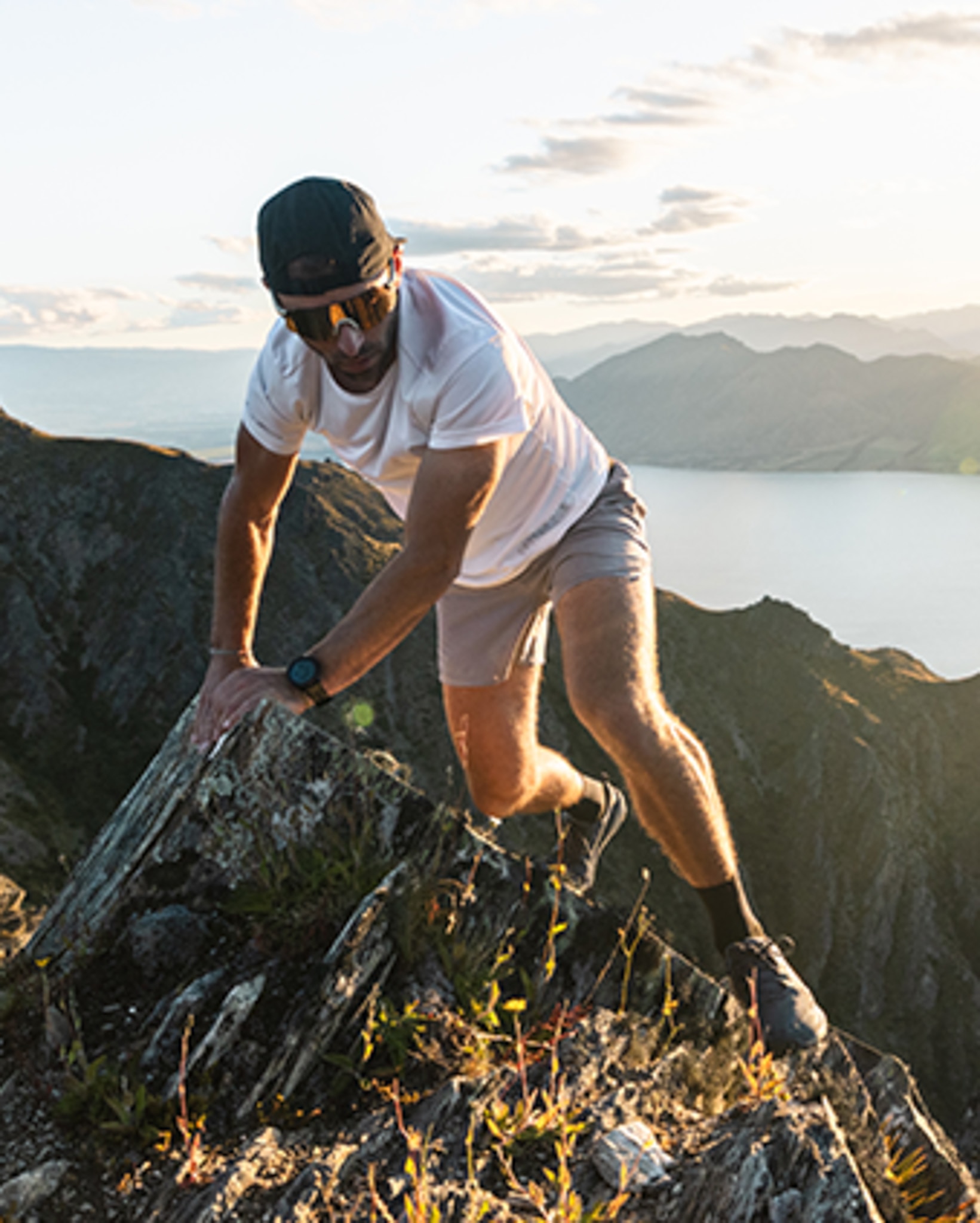 A hiker sitting on a rock showing the shoe outsole