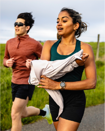 A man and woman running on a road