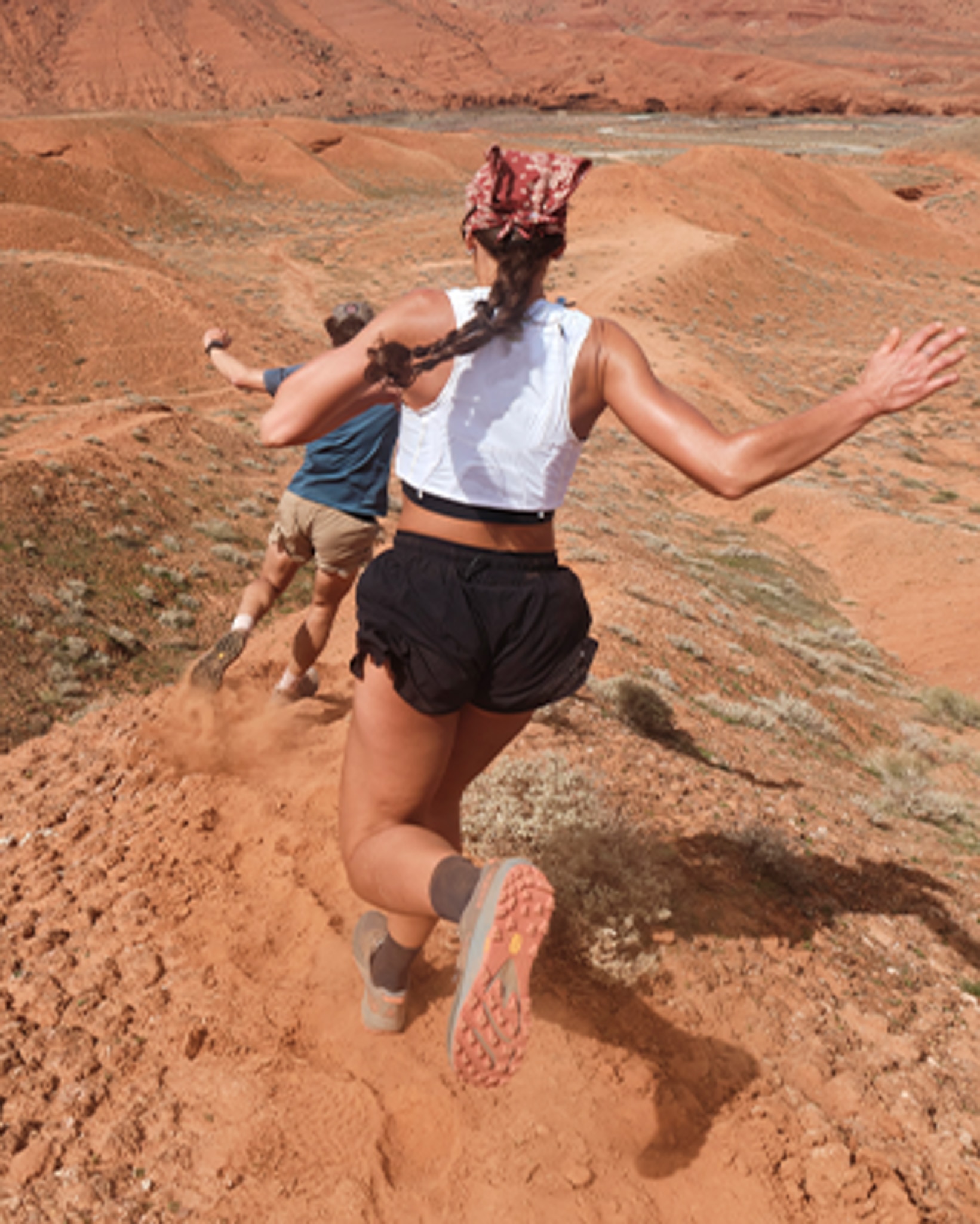 Two people trail running through the mountains